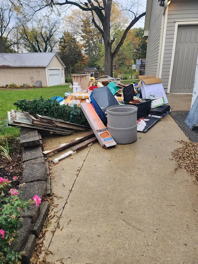 Dumpster being loaded with debris for Estate Cleanout Dumpster Rental in West Lealman